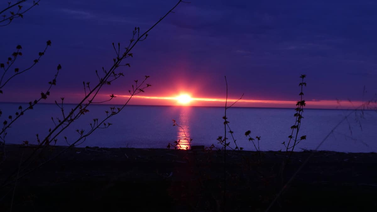 Sun dropping below the Lake Superior horizon