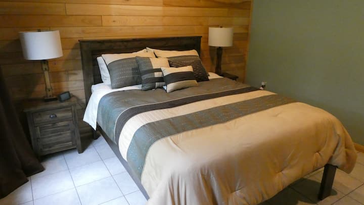 Main-floor queen bed and bedside tables