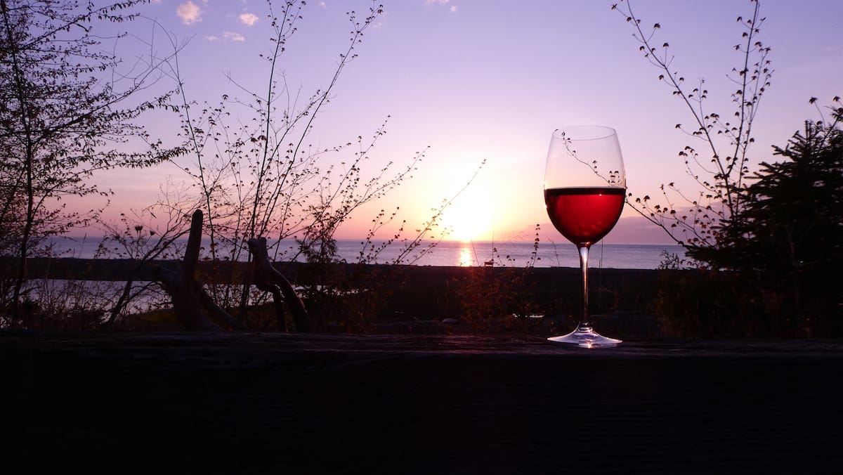A glass of wine at sunset