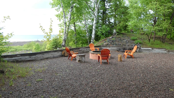 Lakeside firepit with orange chairs