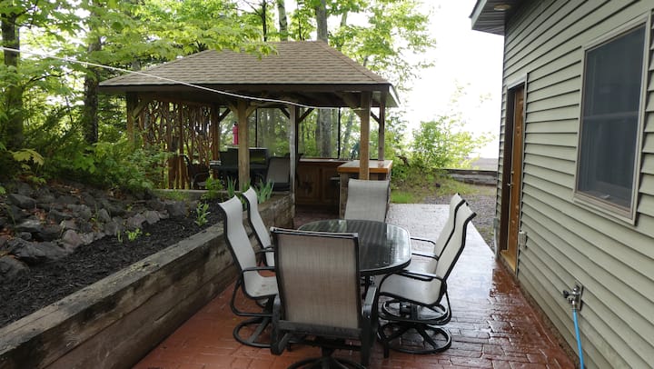 Covered outdoor gathering area beside the home
