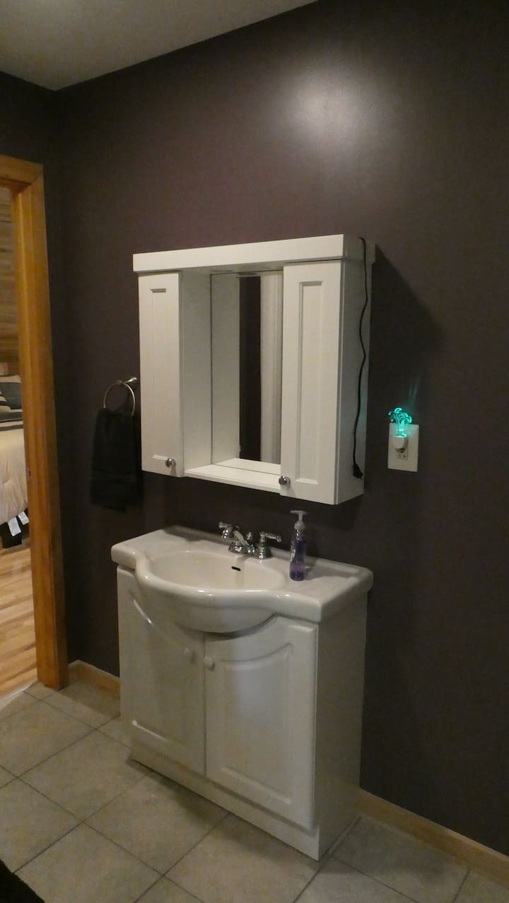 Bathroom sink, mirror, and shower