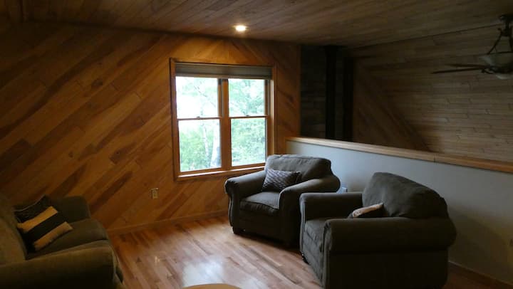 Loft sitting area with wooded view